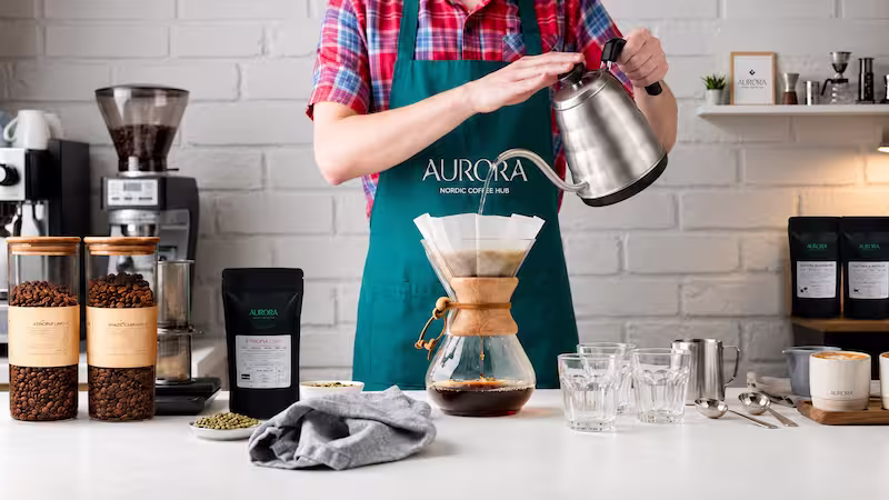 Pour-over brewing at Aurora Nordic Coffee Hub Proffessional Barista Preparing Chemex Coffee at Aurora Coffee Hub